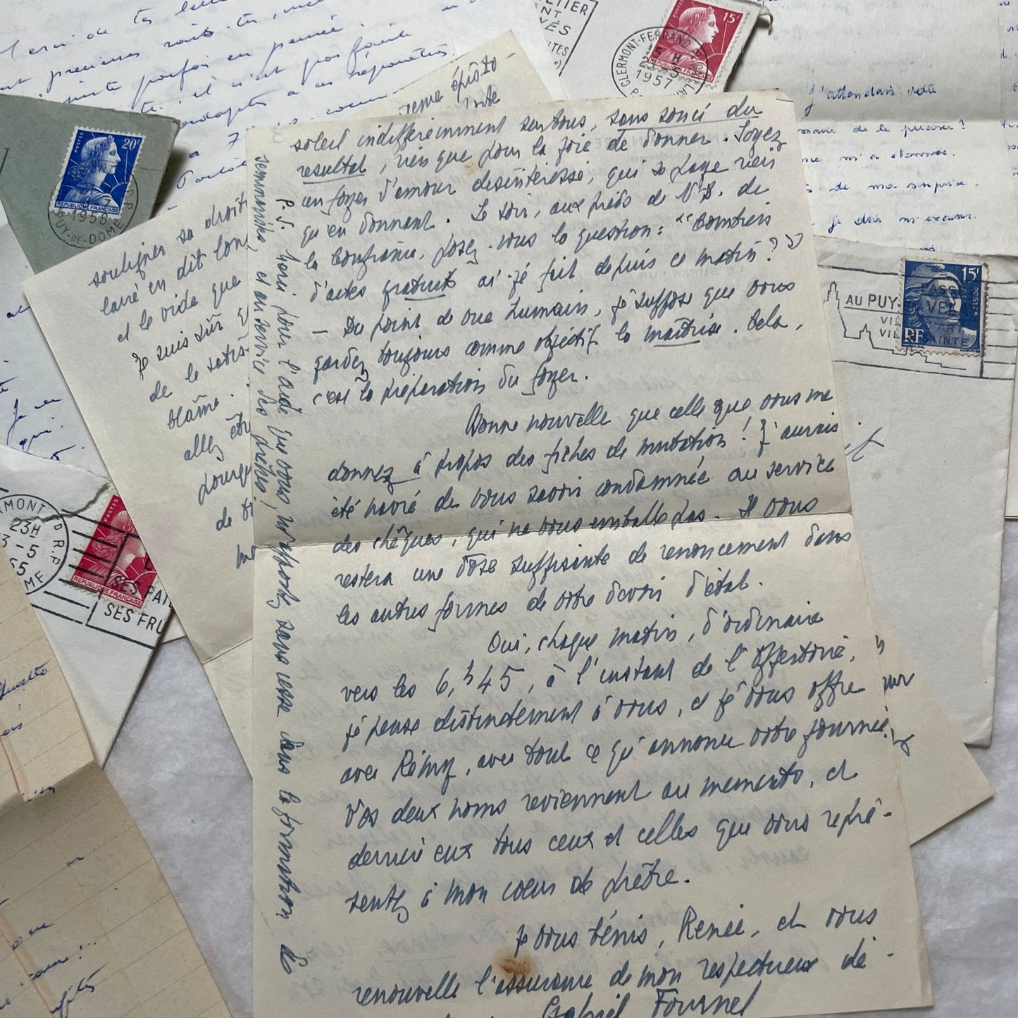 A set of 1950s French letters and envelopes with handwritten text, original stamps, and various postmarks from France.