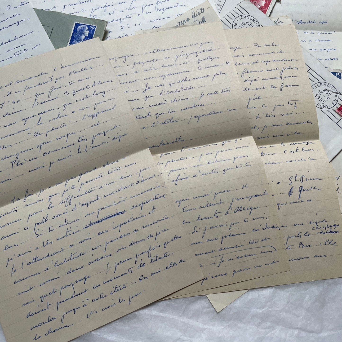 A set of 1950s French letters and envelopes with handwritten text, original stamps, and various postmarks from France.