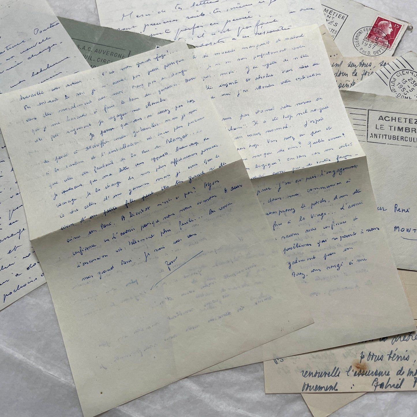 A set of 1950s French letters and envelopes with handwritten text, original stamps, and various postmarks from France.