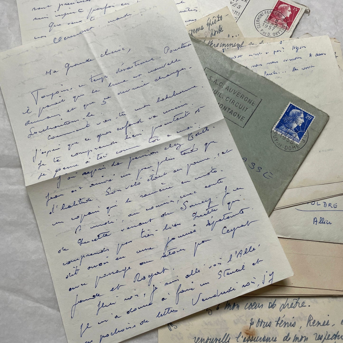 A set of 1950s French letters and envelopes with handwritten text, original stamps, and various postmarks from France.