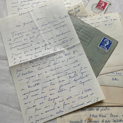 A set of 1950s French letters and envelopes with handwritten text, original stamps, and various postmarks from France.