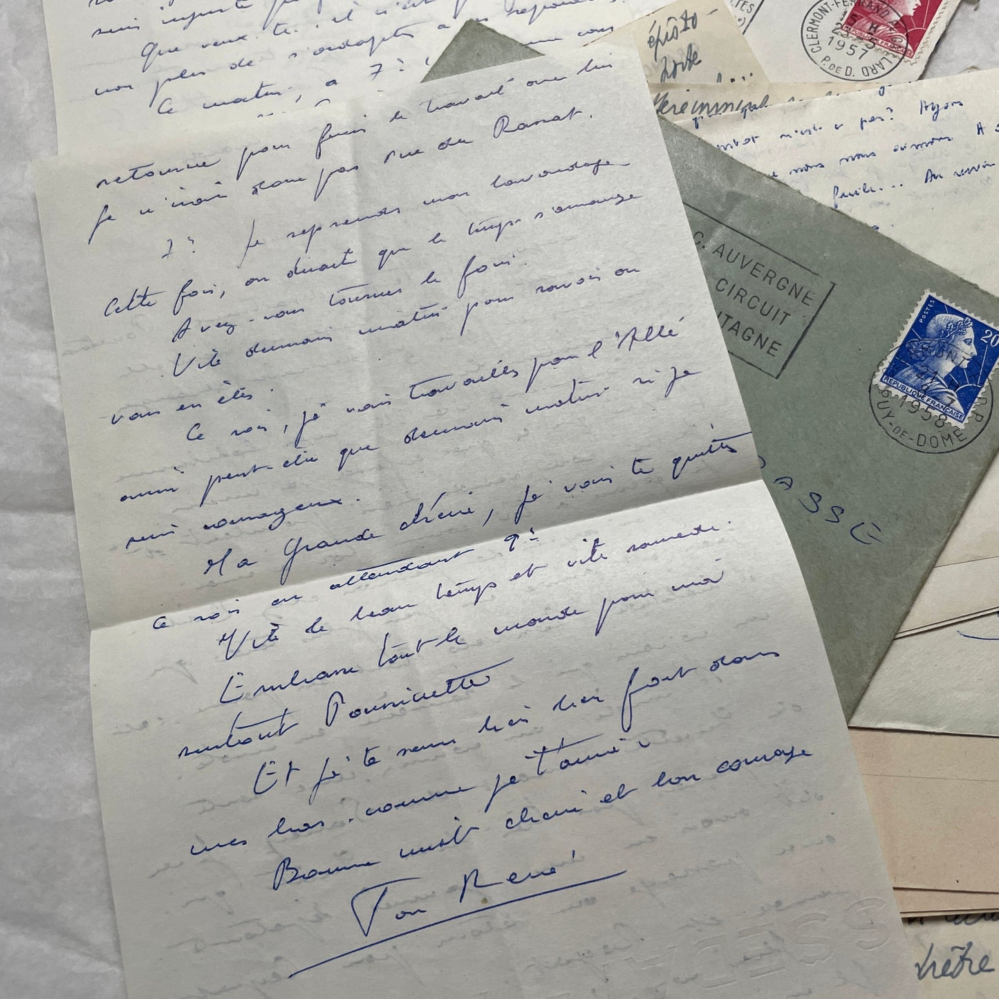 A set of 1950s French letters and envelopes with handwritten text, original stamps, and various postmarks from France.