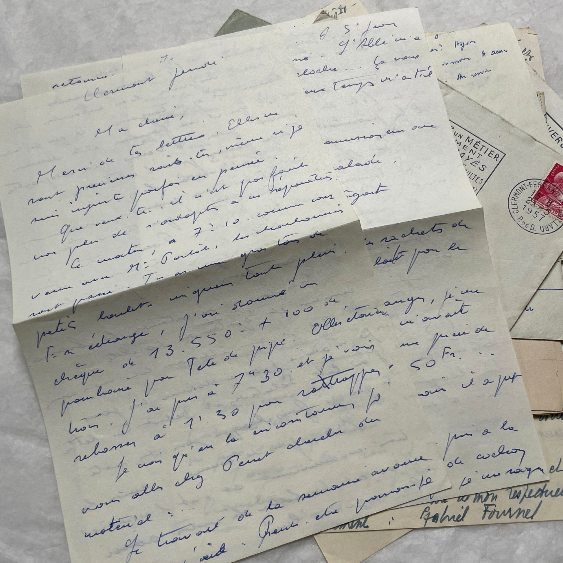 A set of 1950s French letters and envelopes with handwritten text, original stamps, and various postmarks from France.