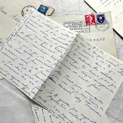 Set of 5 1950s French handwritten letters with envelopes, visible postage stamps and cursive text in French.