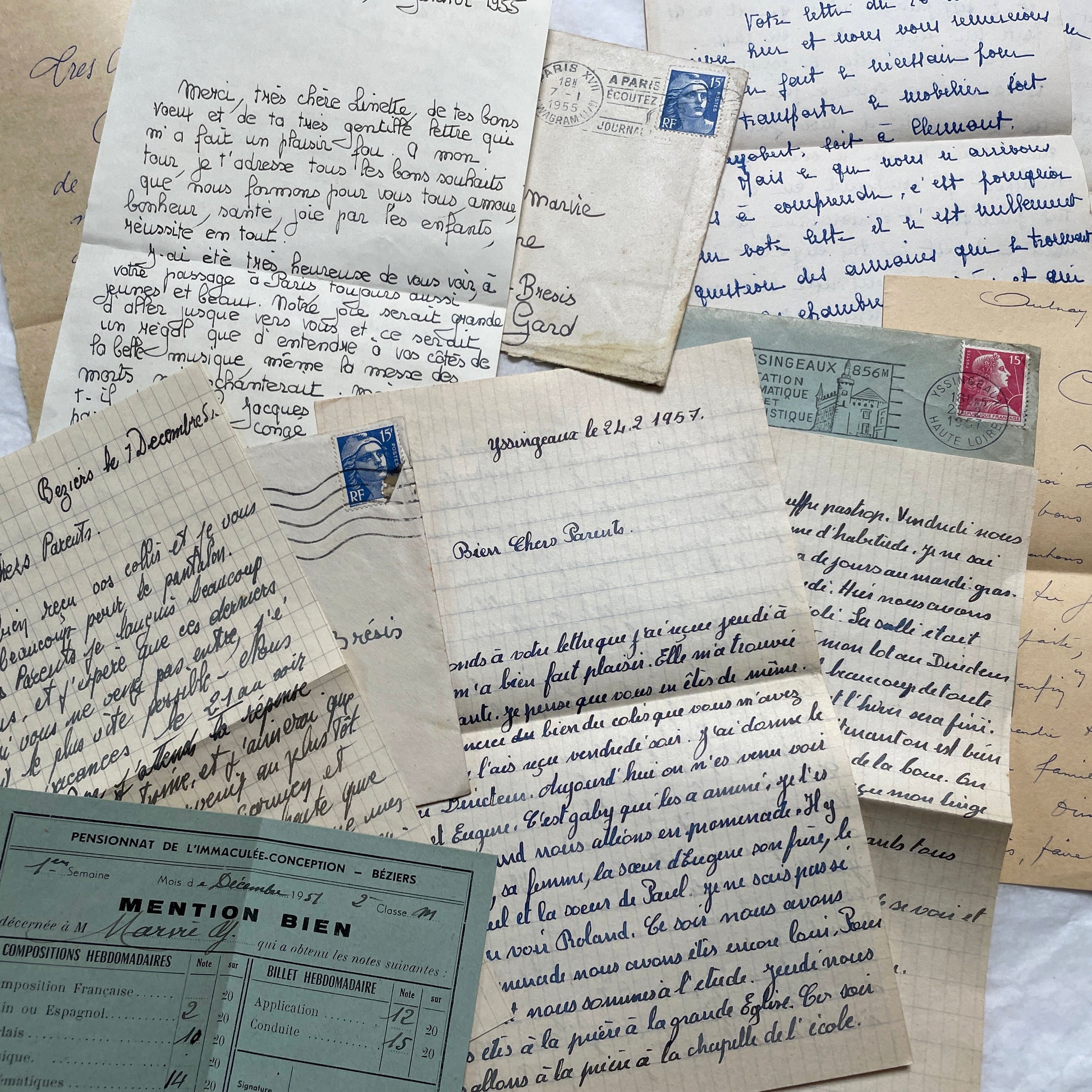 Five 1950s French handwritten letters with envelopes, showing vintage stamps and unique cursive script.