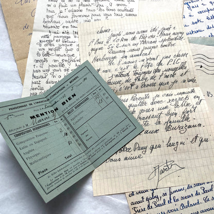 Five 1950s French handwritten letters with envelopes, showing vintage stamps and unique cursive script.
