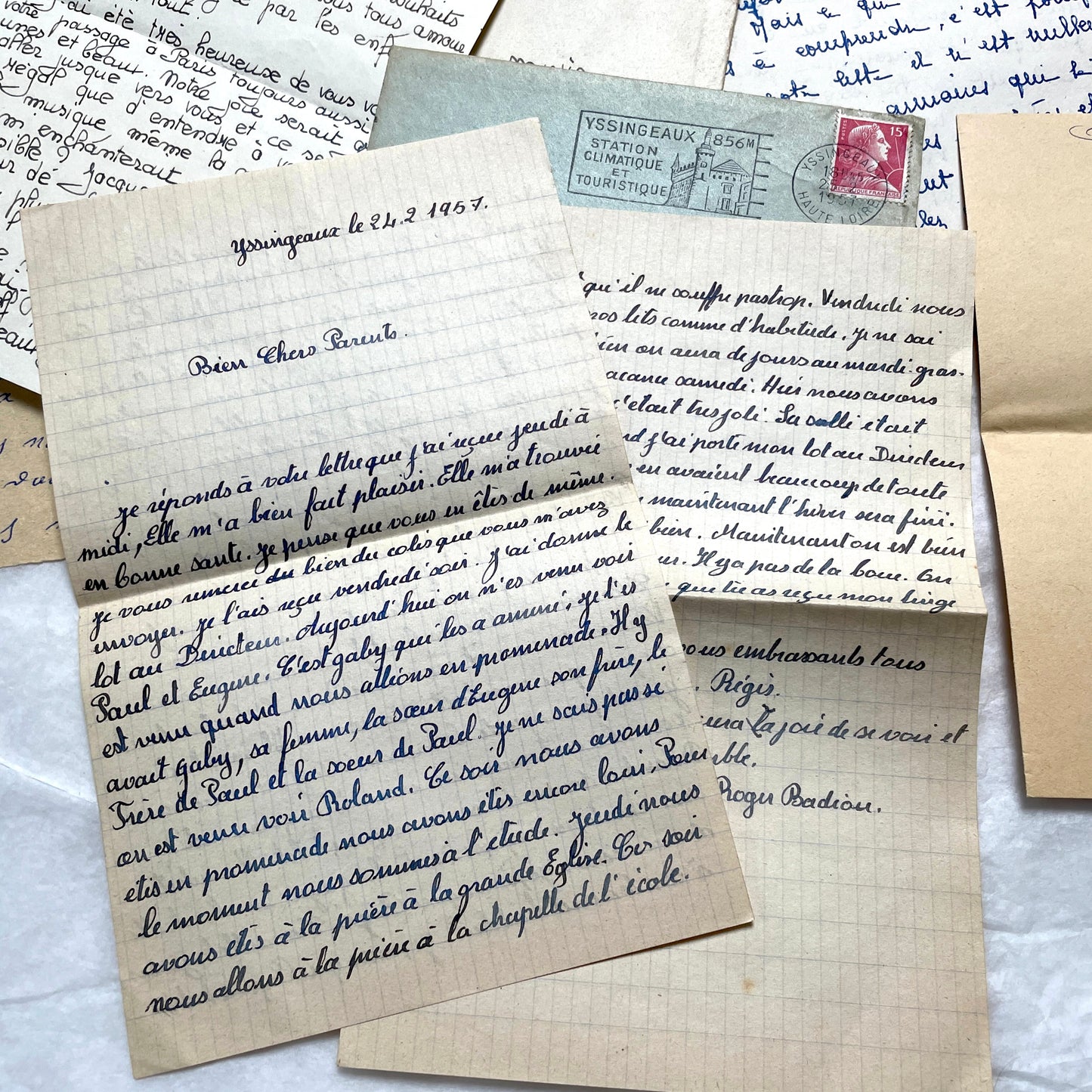 Five 1950s French handwritten letters with envelopes, showing vintage stamps and unique cursive script.