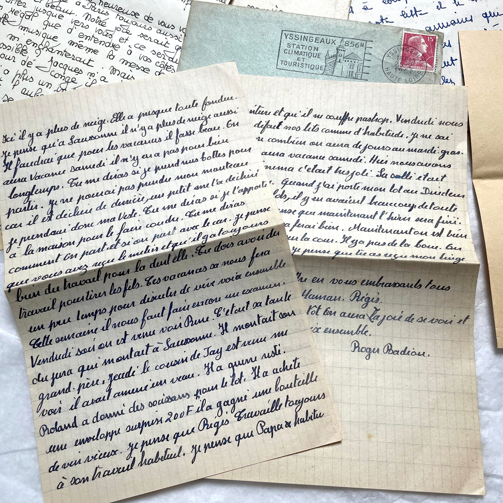 Five 1950s French handwritten letters with envelopes, showing vintage stamps and unique cursive script.