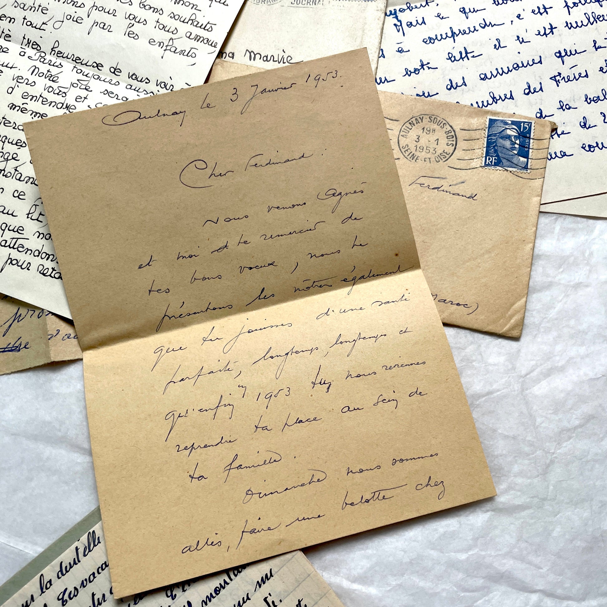 Five 1950s French handwritten letters with envelopes, showing vintage stamps and unique cursive script.