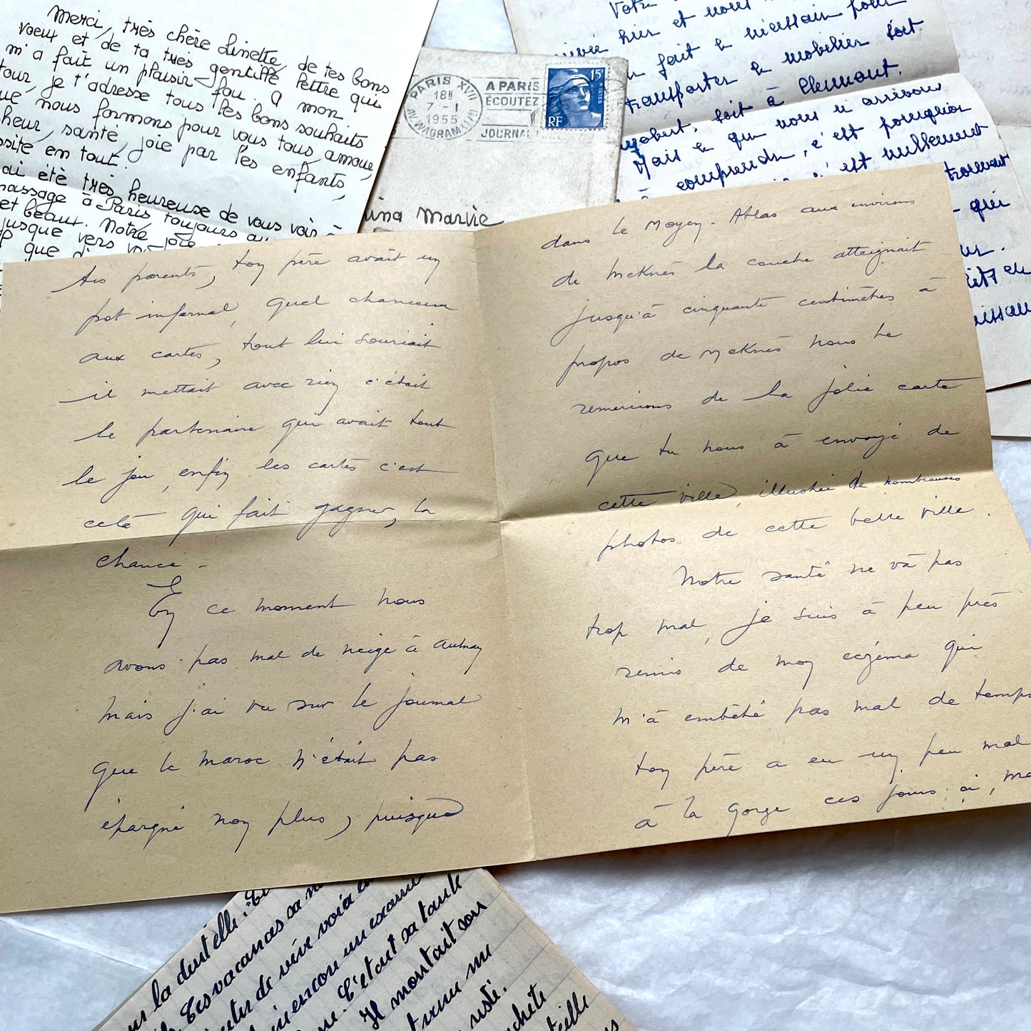 Five 1950s French handwritten letters with envelopes, showing vintage stamps and unique cursive script.