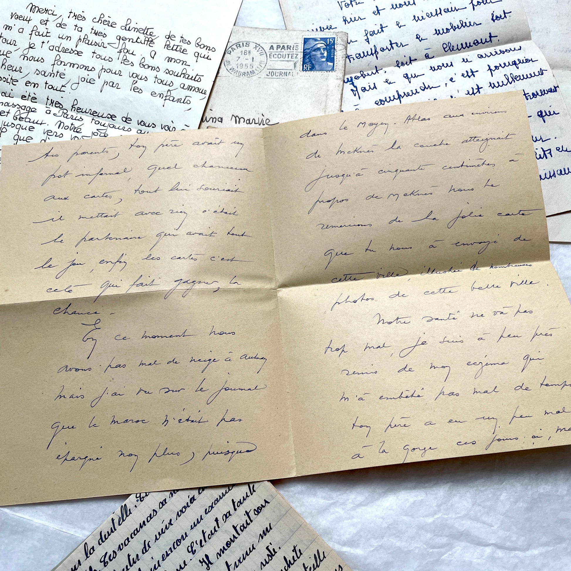 Five 1950s French handwritten letters with envelopes, showing vintage stamps and unique cursive script.