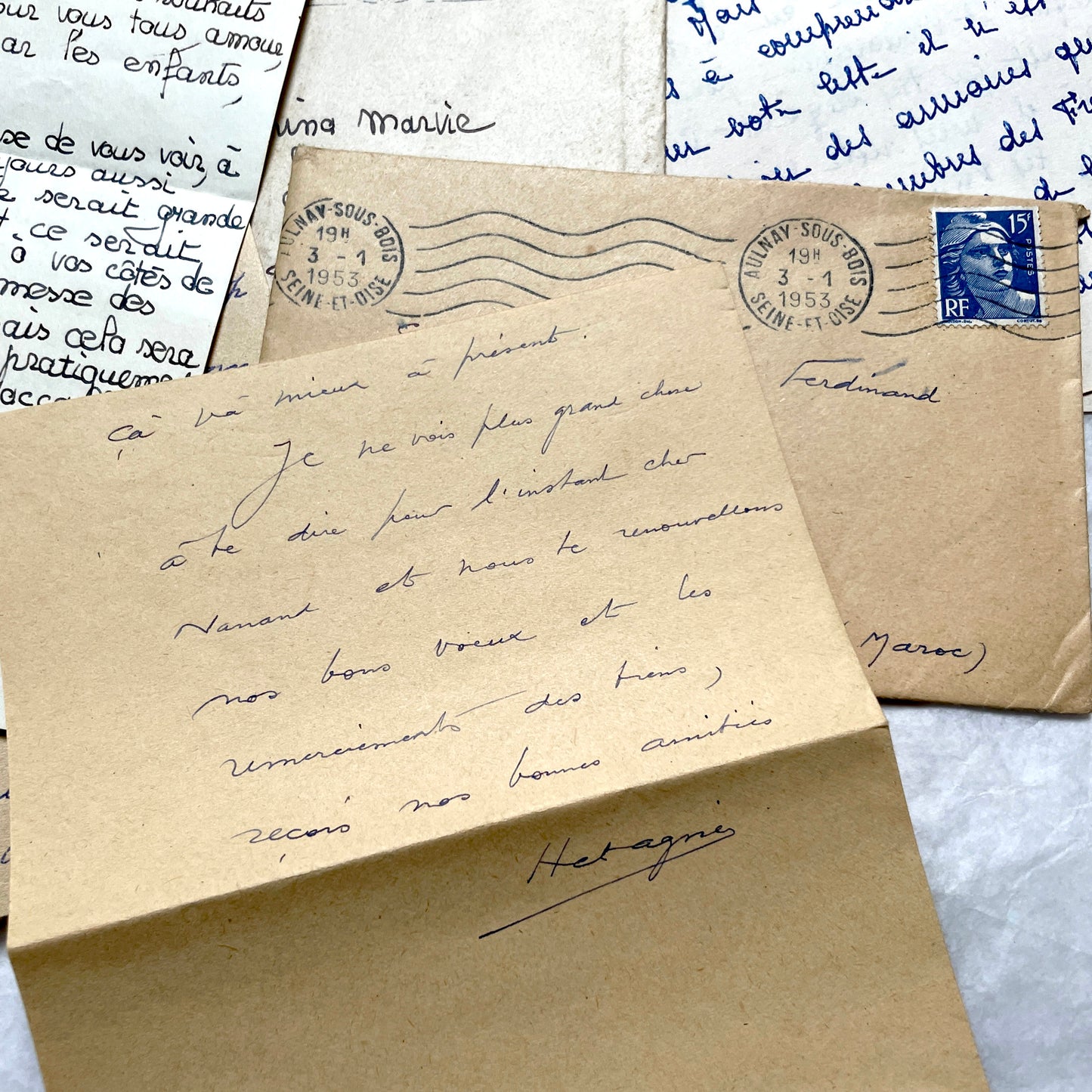 Five 1950s French handwritten letters with envelopes, showing vintage stamps and unique cursive script.