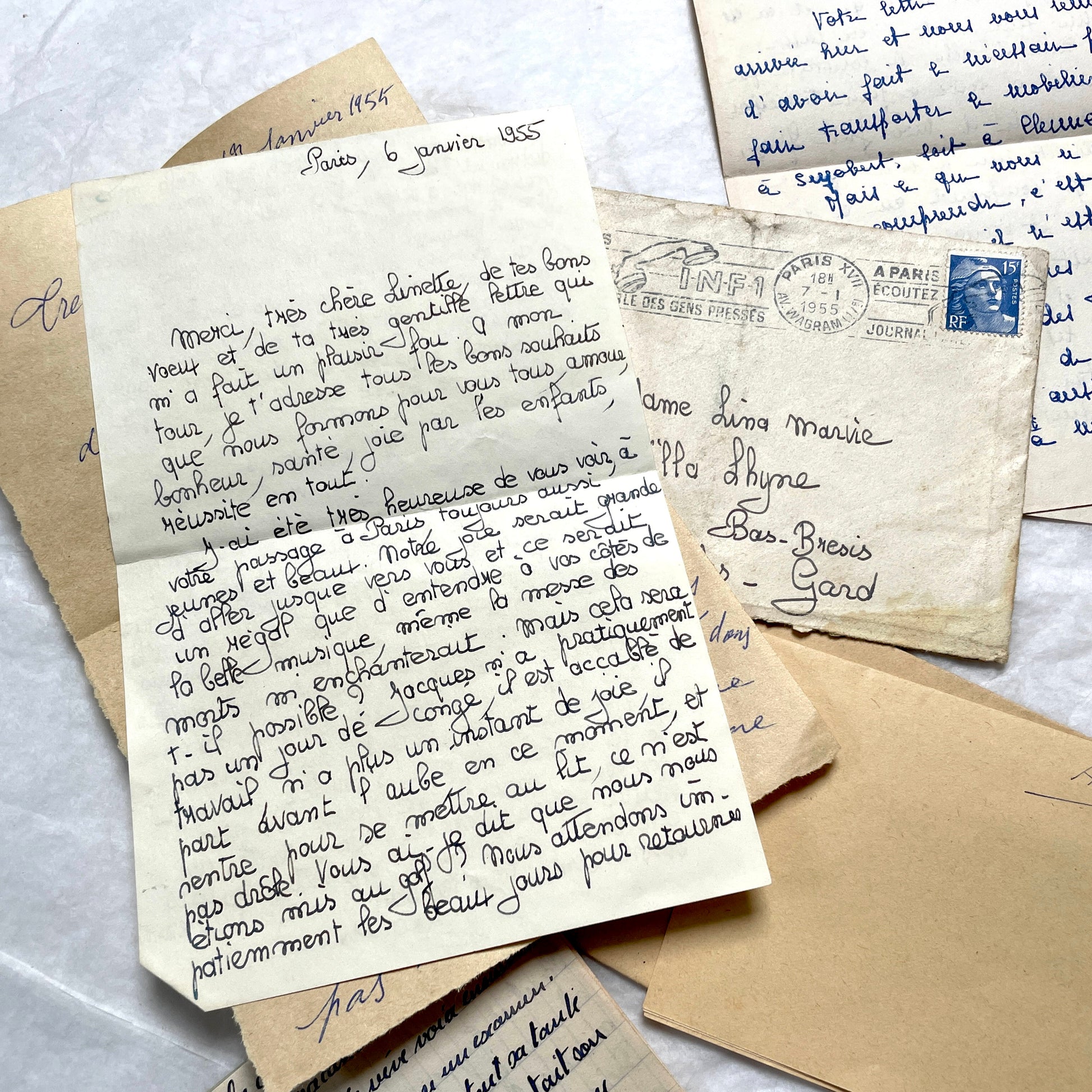 Five 1950s French handwritten letters with envelopes, showing vintage stamps and unique cursive script.