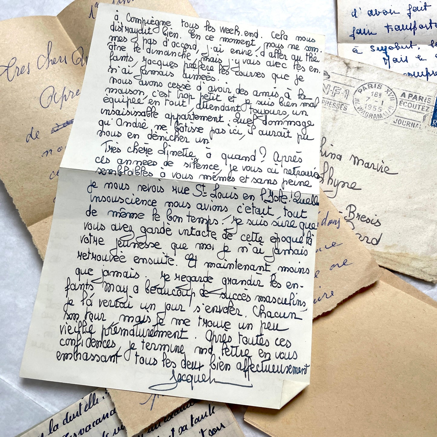 Five 1950s French handwritten letters with envelopes, showing vintage stamps and unique cursive script.