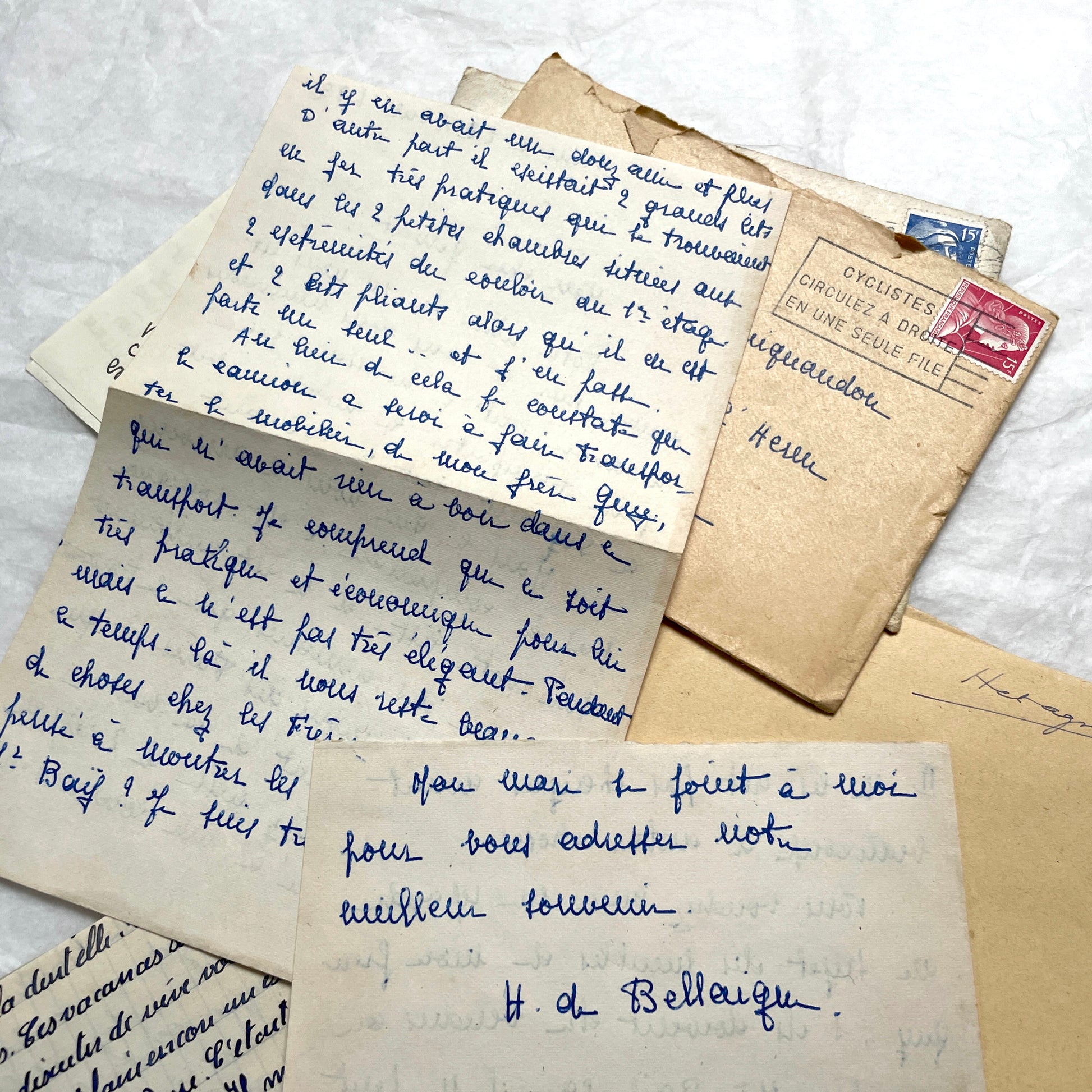 Five 1950s French handwritten letters with envelopes, showing vintage stamps and unique cursive script.