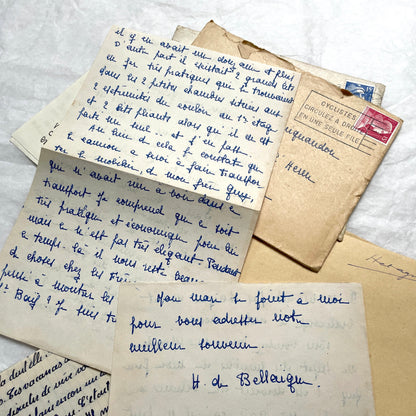 Five 1950s French handwritten letters with envelopes, showing vintage stamps and unique cursive script.