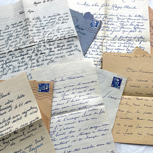 1950s French handwritten letter set with original envelopes and vintage postage stamps, showing cursive script.