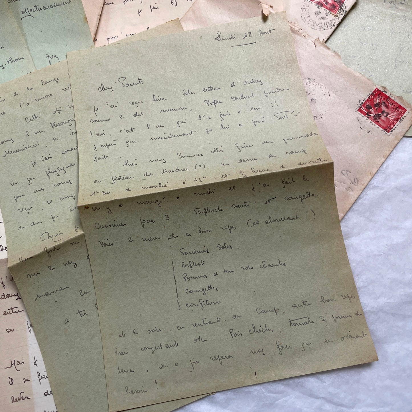 Five French handwritten letters and envelopes from the 1940s, featuring period postage stamps and script.
