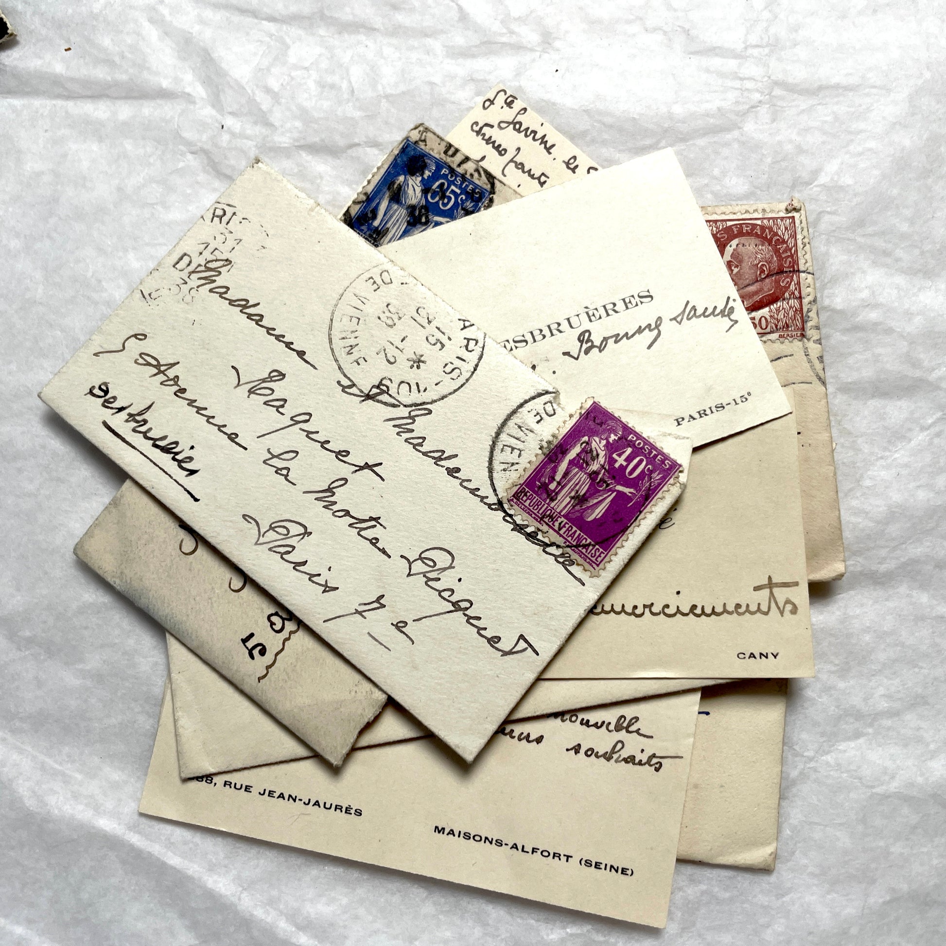 Lot of 10 French 1930s miniature envelopes with handwritten notes, business cards, and vintage stamps.