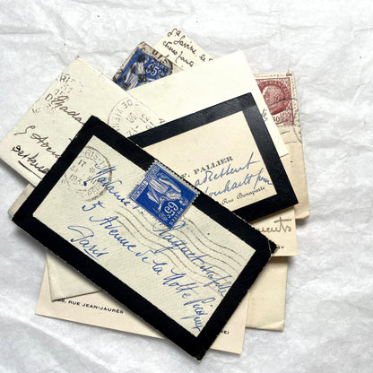 Lot of 10 French 1930s miniature envelopes with handwritten notes, business cards, and vintage stamps.