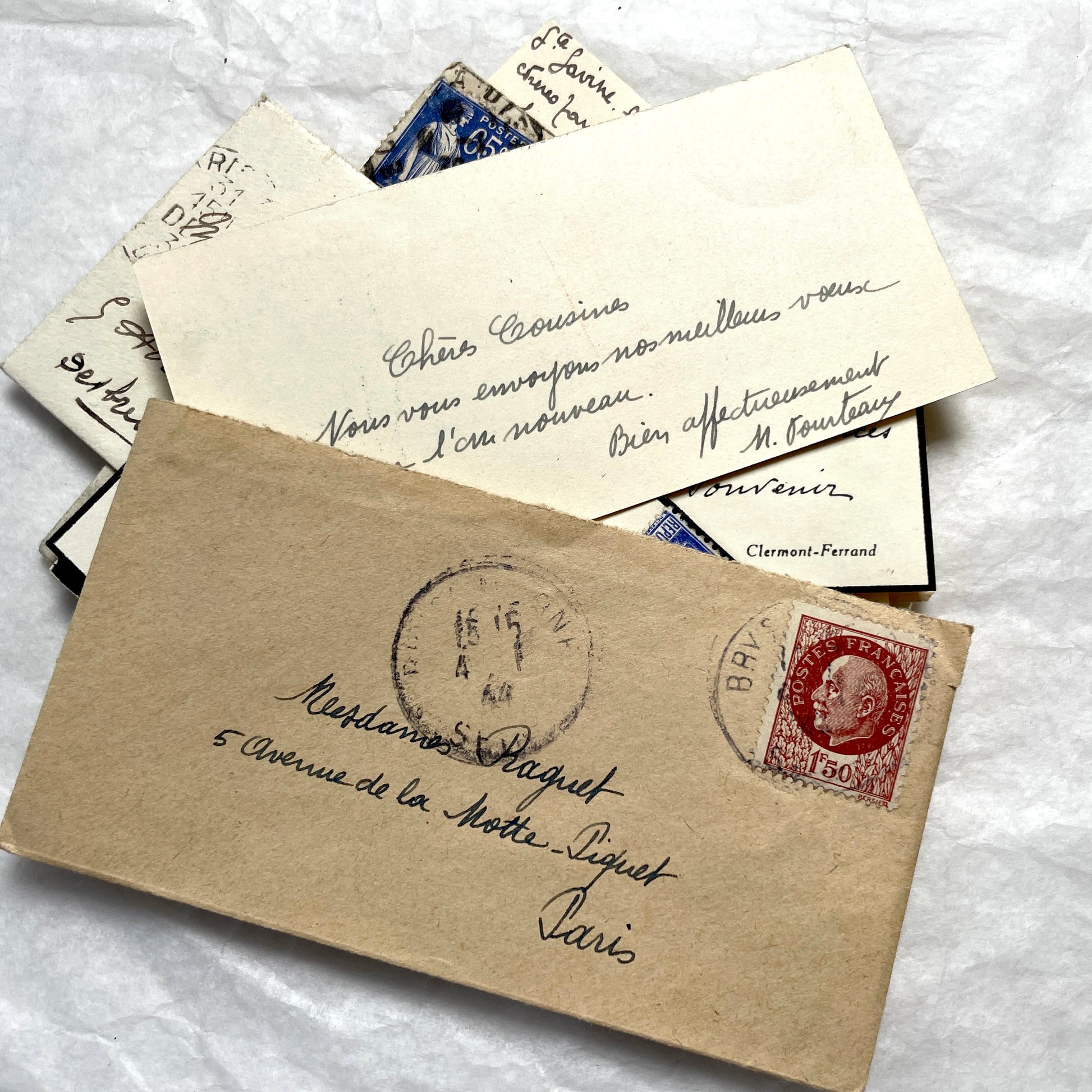 Lot of 10 French 1930s miniature envelopes with handwritten notes, business cards, and vintage stamps.