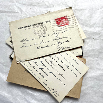 Lot of 10 French 1930s miniature envelopes with handwritten notes, business cards, and vintage stamps.