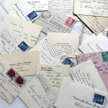 Lot of 10 1950s French ephemera small envelopes with handwritten notes, stamps, and postmarks.