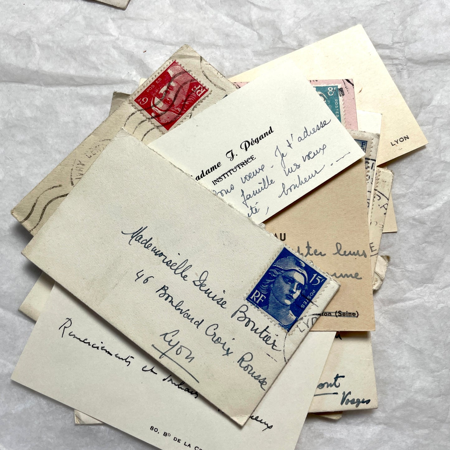 Lot of 10 1950s French ephemera small envelopes with handwritten notes, stamps, and postmarks.