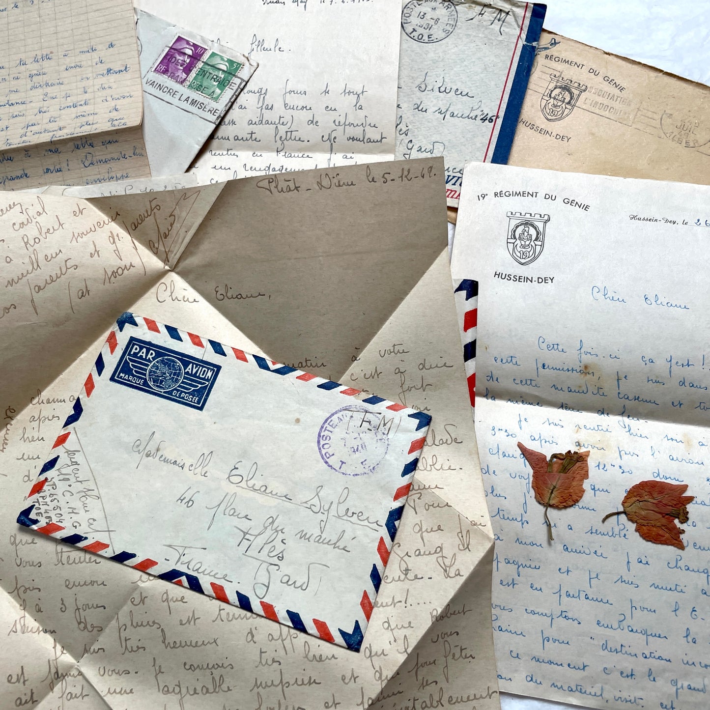 Set of 1940s French letters and envelopes, featuring handwritten notes, postal stamps, and vintage airmail details.
