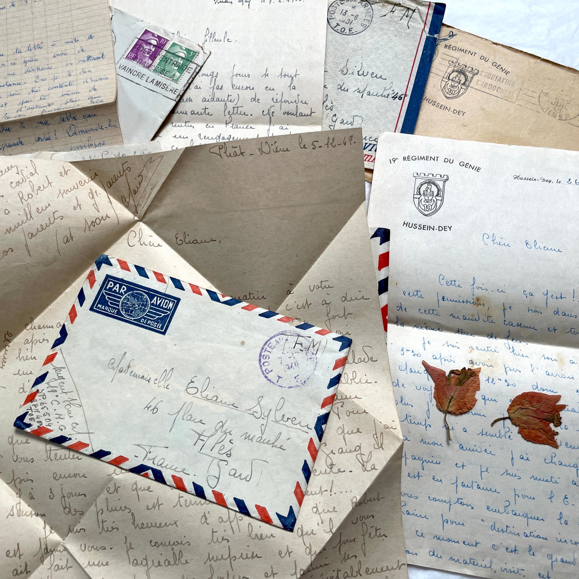 Set of 1940s French letters and envelopes, featuring handwritten notes, postal stamps, and vintage airmail details.