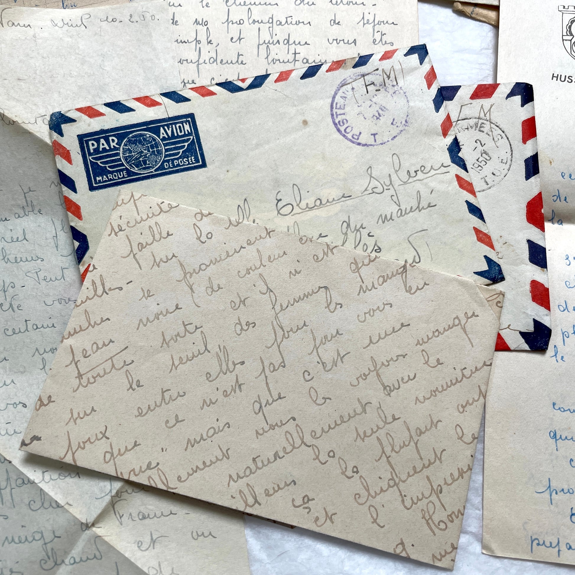 Set of 1940s French letters and envelopes, featuring handwritten notes, postal stamps, and vintage airmail details.