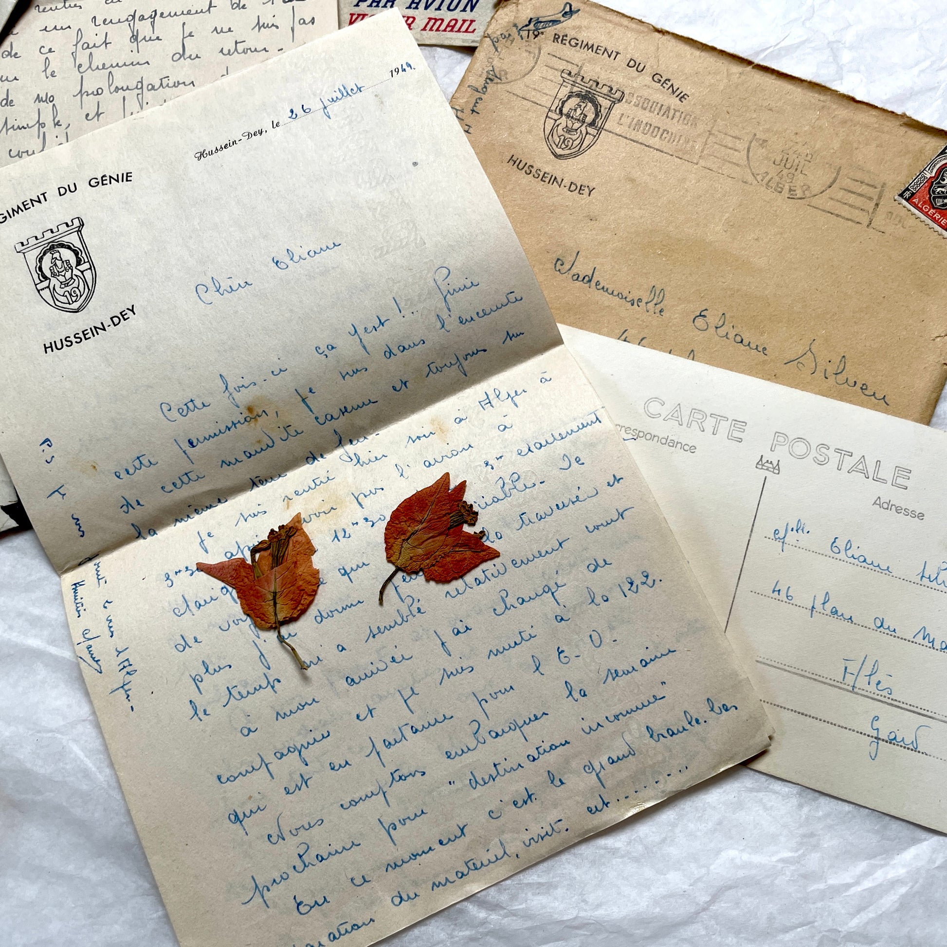 Set of 1940s French letters and envelopes, featuring handwritten notes, postal stamps, and vintage airmail details.