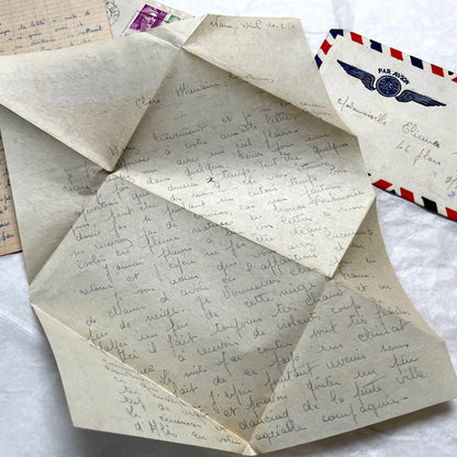 Set of 1940s French letters and envelopes, featuring handwritten notes, postal stamps, and vintage airmail details.