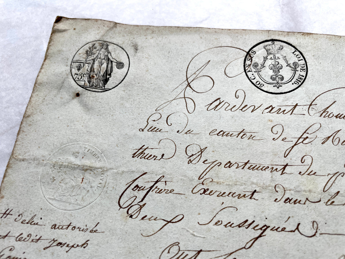 1810s French notarial act - detailed handwritten legal document with official stamps and elegant French script.