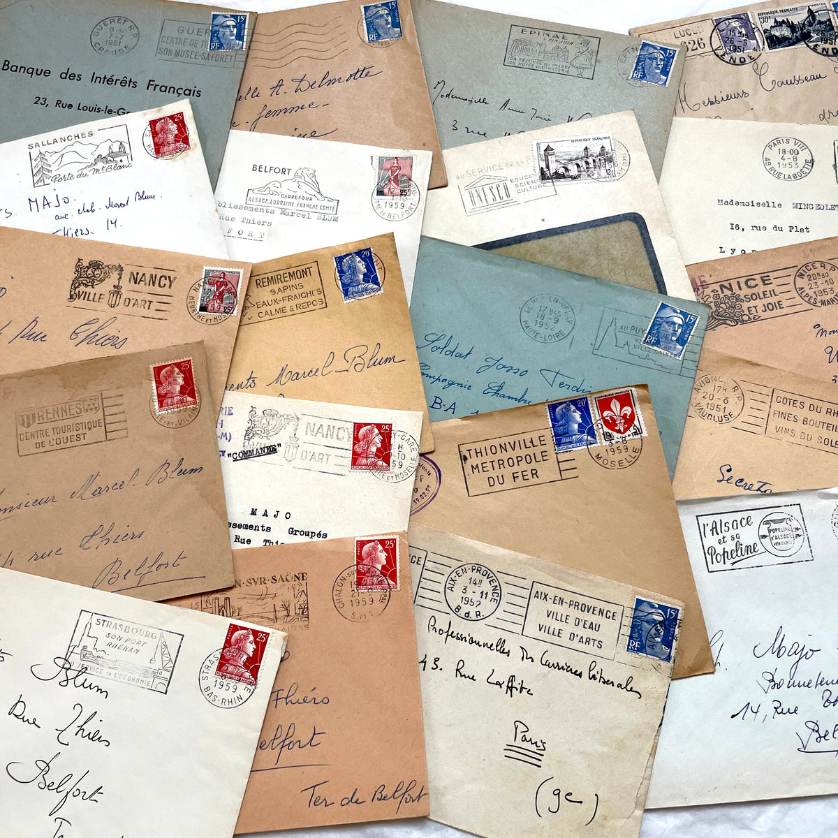 Lot of 20 French envelopes from the 1950s, featuring various postmarks, stamps, and handwritten addresses.