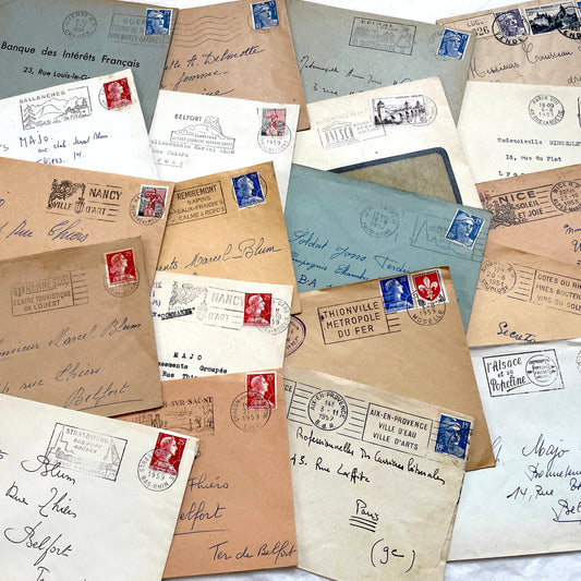 Lot of 20 French envelopes from the 1950s, featuring various postmarks, stamps, and handwritten addresses.