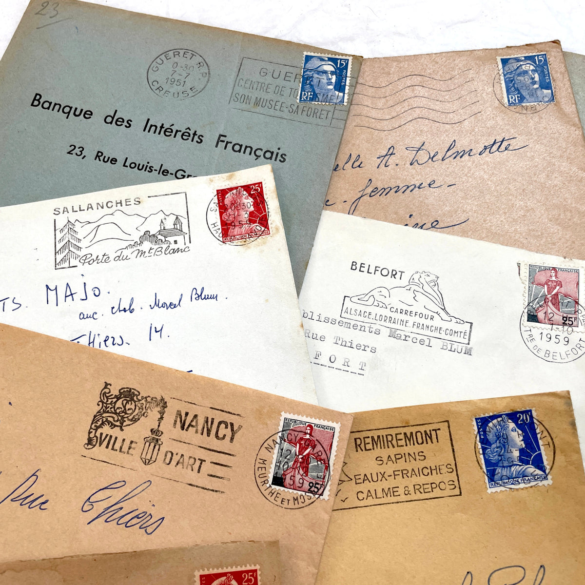 Lot of 20 French envelopes from the 1950s, featuring various postmarks, stamps, and handwritten addresses.