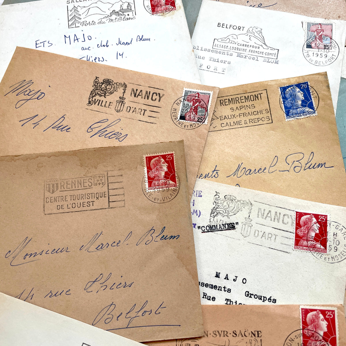 Lot of 20 French envelopes from the 1950s, featuring various postmarks, stamps, and handwritten addresses.