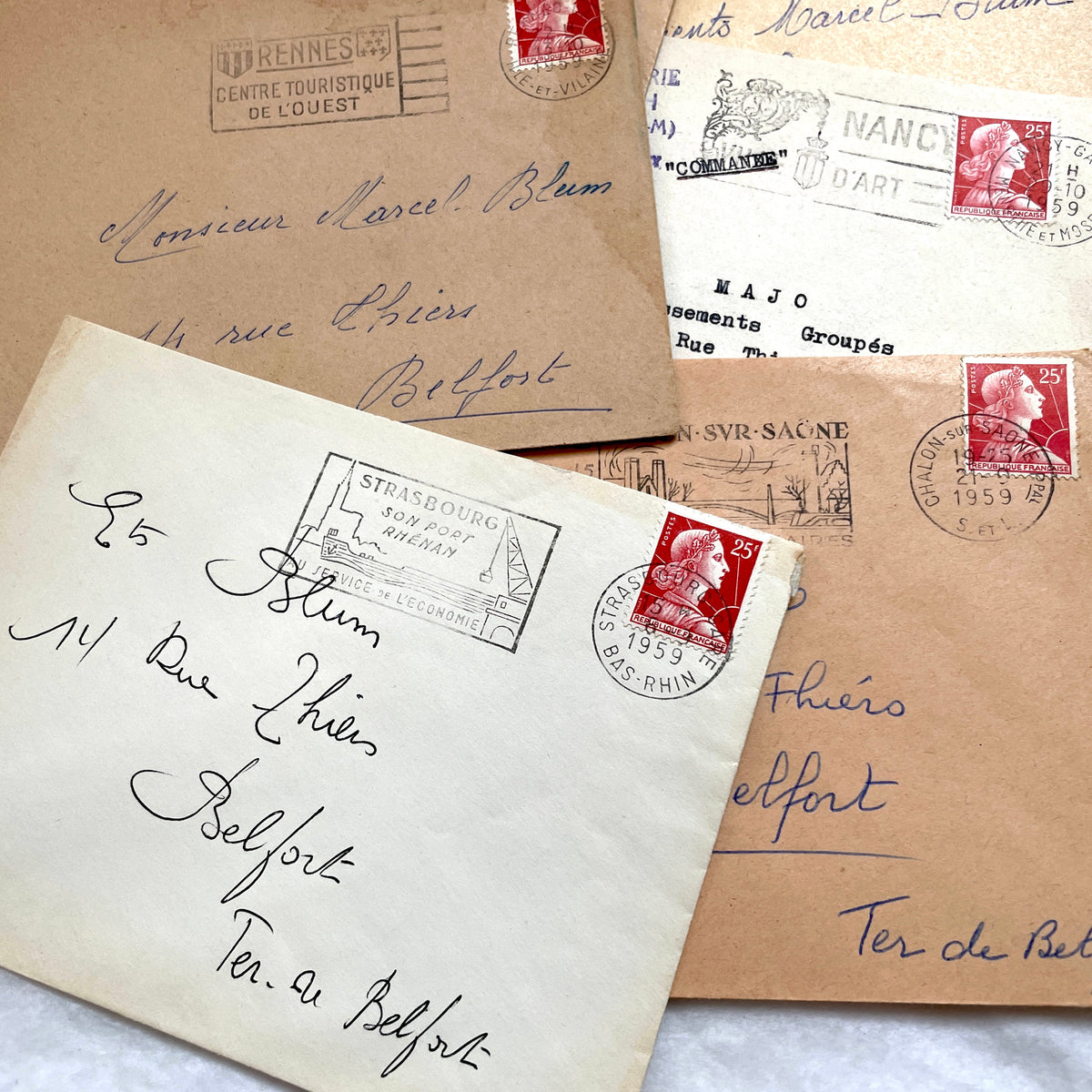 Lot of 20 French envelopes from the 1950s, featuring various postmarks, stamps, and handwritten addresses.