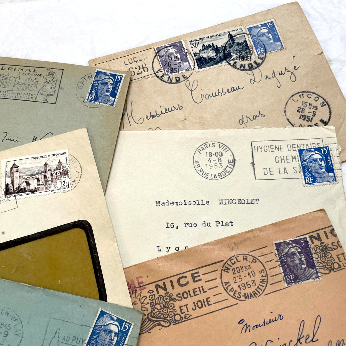 Lot of 20 French envelopes from the 1950s, featuring various postmarks, stamps, and handwritten addresses.