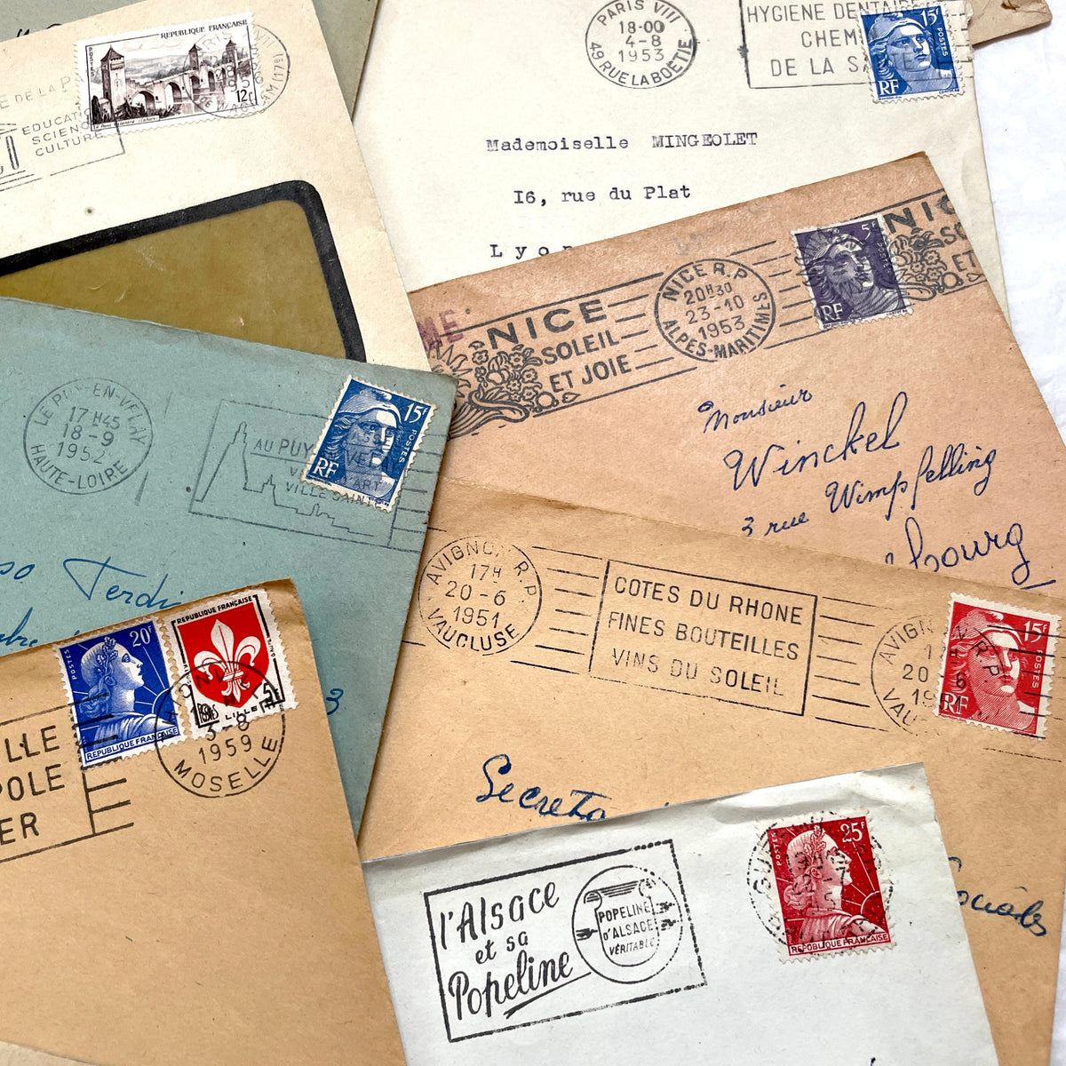 Lot of 20 French envelopes from the 1950s, featuring various postmarks, stamps, and handwritten addresses.