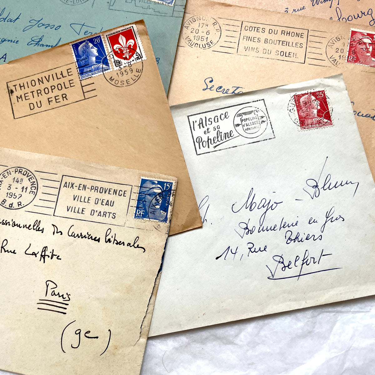 Lot of 20 French envelopes from the 1950s, featuring various postmarks, stamps, and handwritten addresses.