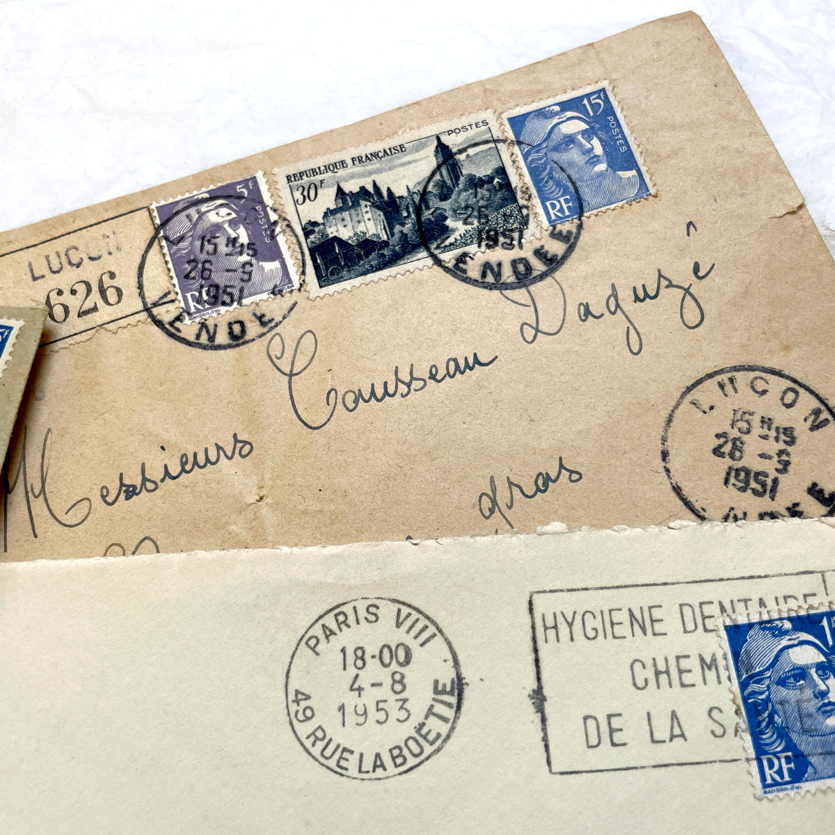 Lot of 20 French envelopes from the 1950s, featuring various postmarks, stamps, and handwritten addresses.