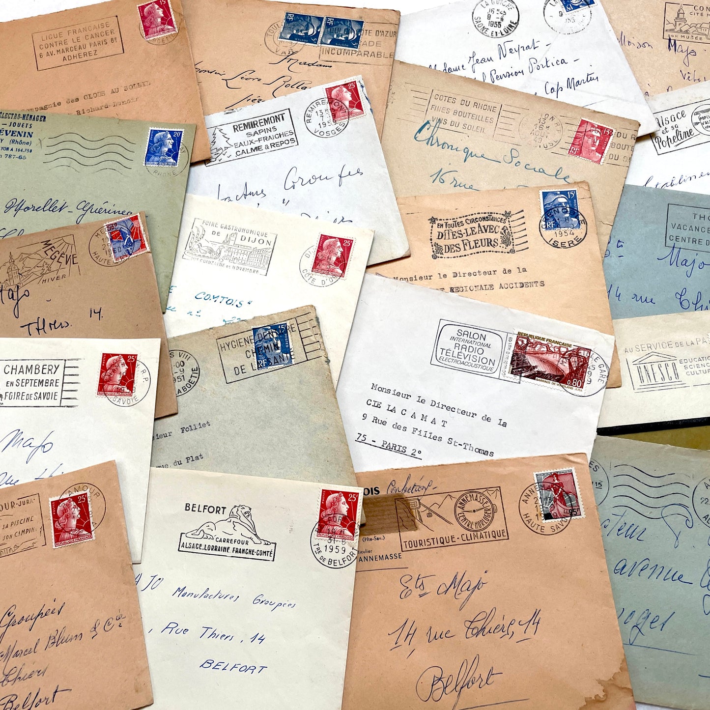 Lot of 20 French envelopes from the 1950s featuring various vintage stamps, postmarks, and handwritten addresses.