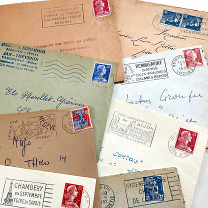 Lot of 20 French envelopes from the 1950s featuring various vintage stamps, postmarks, and handwritten addresses.