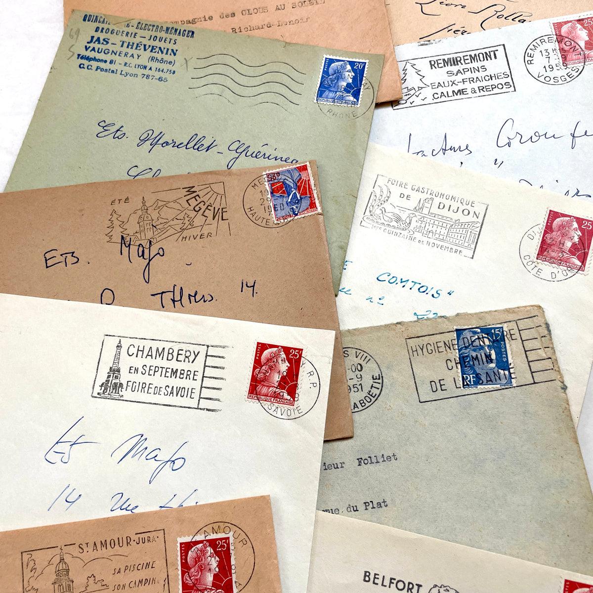 Lot of 20 French envelopes from the 1950s featuring various vintage stamps, postmarks, and handwritten addresses.