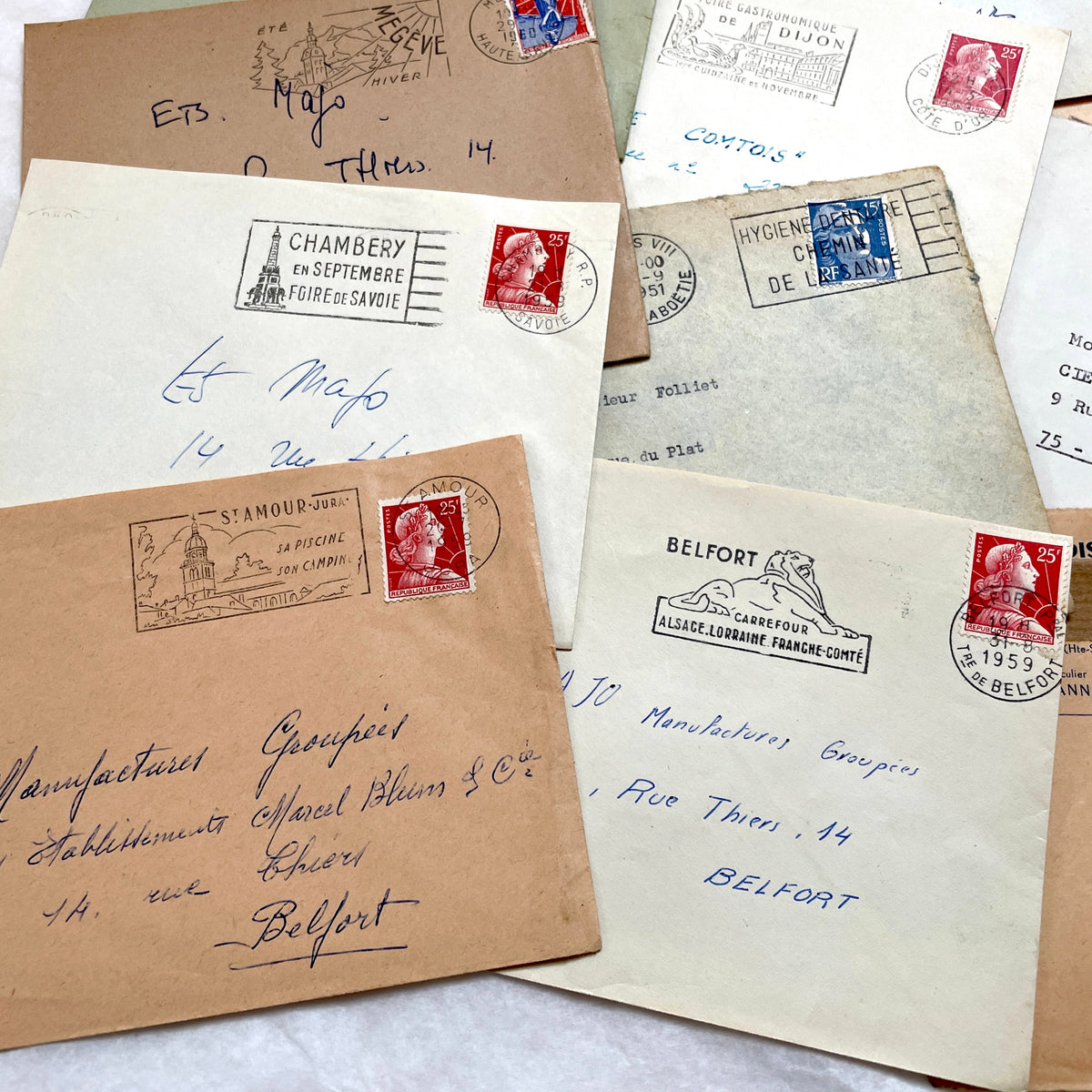 Lot of 20 French envelopes from the 1950s featuring various vintage stamps, postmarks, and handwritten addresses.