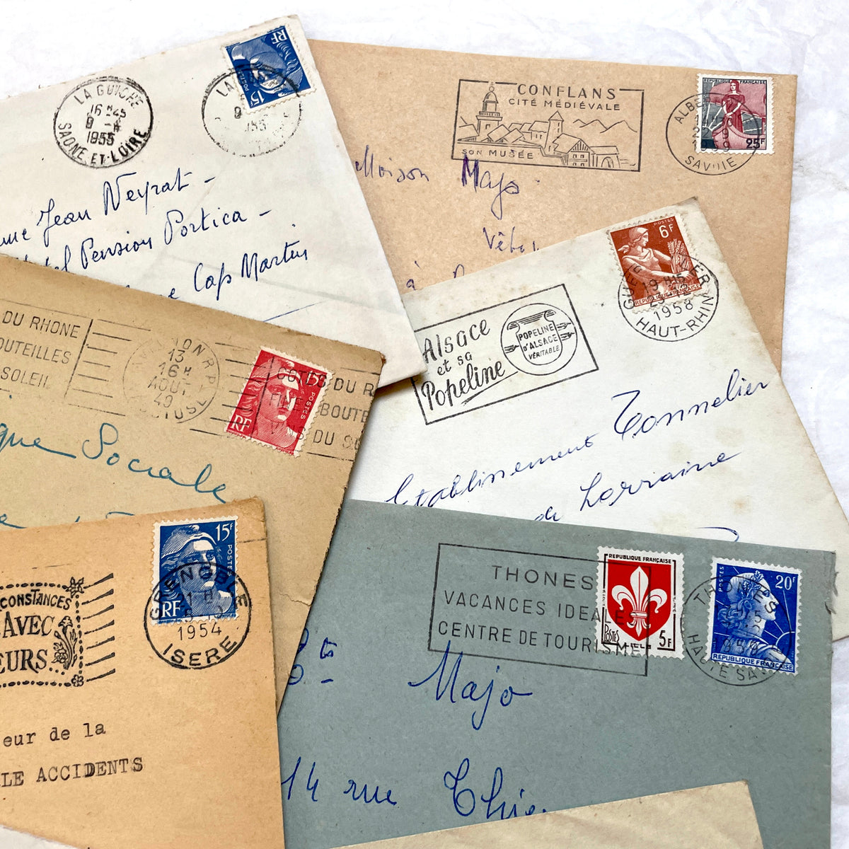 Lot of 20 French envelopes from the 1950s featuring various vintage stamps, postmarks, and handwritten addresses.