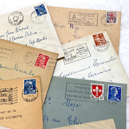 Lot of 20 French envelopes from the 1950s featuring various vintage stamps, postmarks, and handwritten addresses.