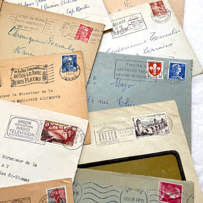 Lot of 20 French envelopes from the 1950s featuring various vintage stamps, postmarks, and handwritten addresses.